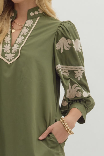 Close-up of cream embroidered detailing on olive green puff sleeve dress — stylish fall fashion from Milo & Lily Boutique.