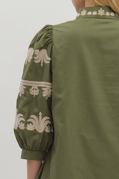 Back view of olive green puff sleeve dress with intricate embroidery — chic boho-inspired boutique dress.