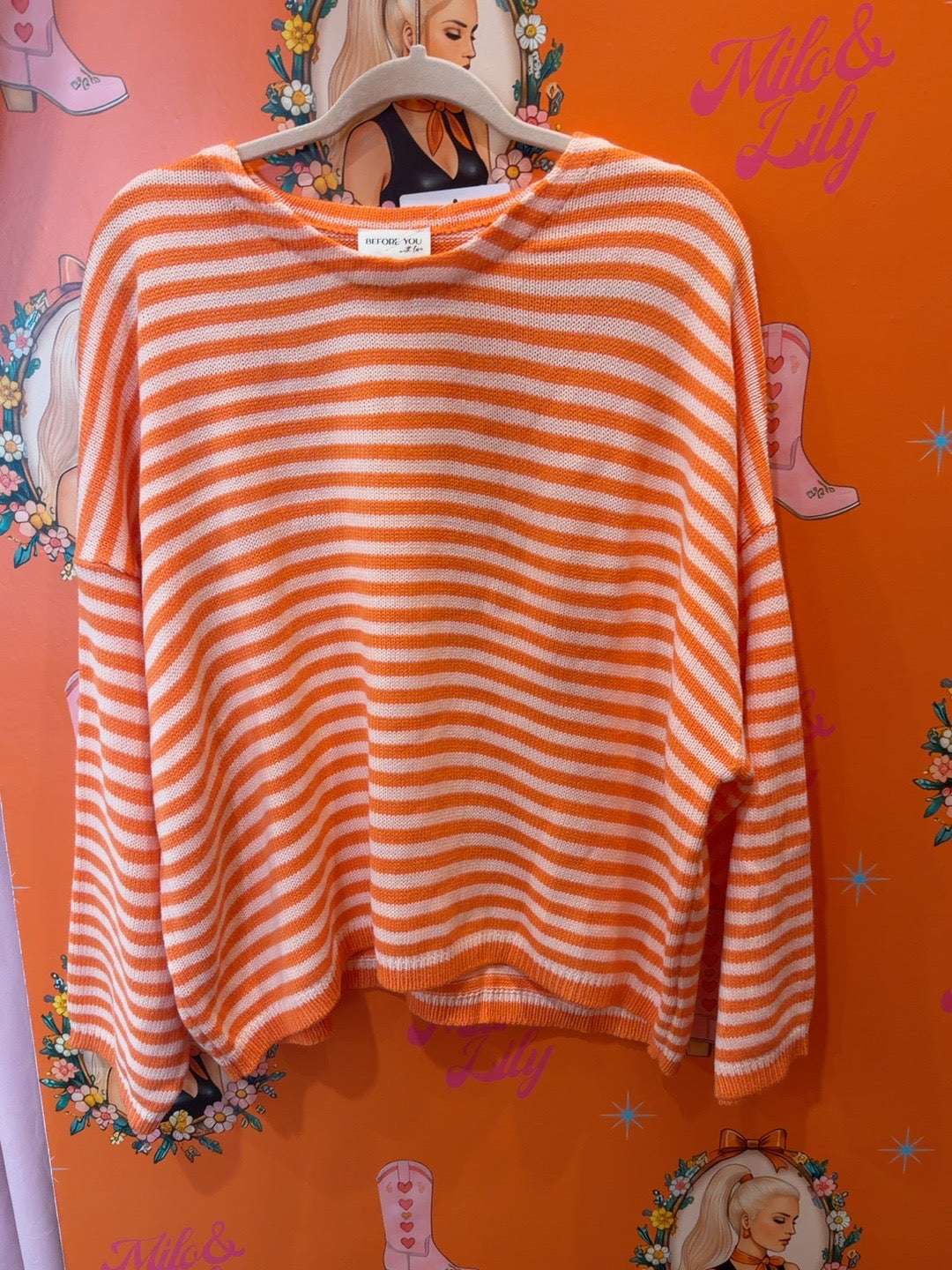 Orange and white striped relaxed knit sweater