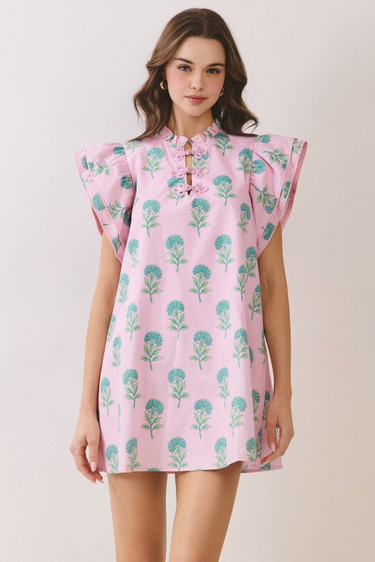 Pink botanical mini dress with flutter sleeves and front tie neckline detail