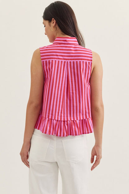 Woman wearing a pink and white striped sleeveless top with a plain background