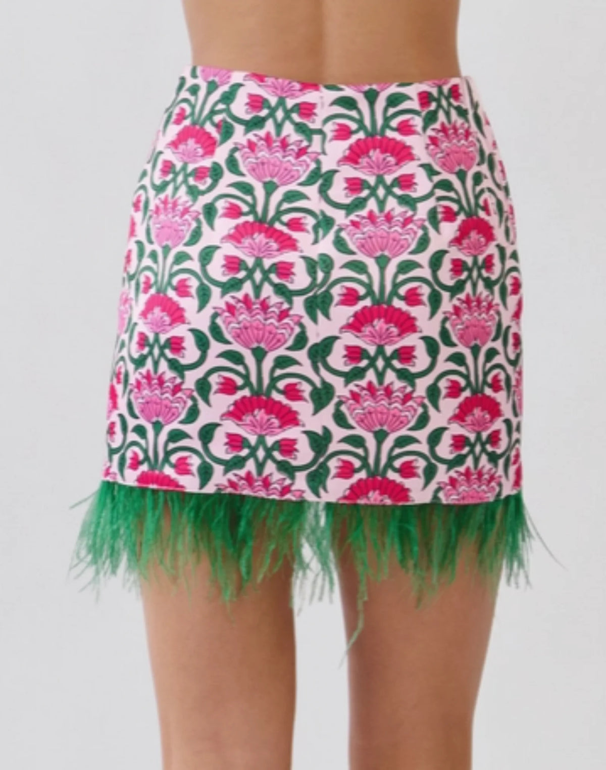 Pink floral mini skirt with green fringe along hem