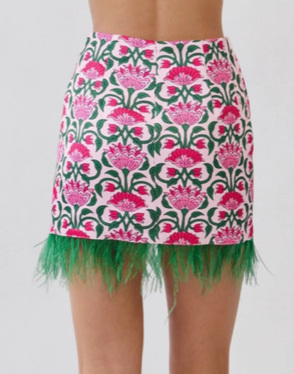 Pink floral mini skirt with green fringe along hem