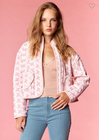Model wearing a pink quilted floral jacket with heart-shaped pockets and cropped fit — Milo & Lily Boutique feminine outerwear.