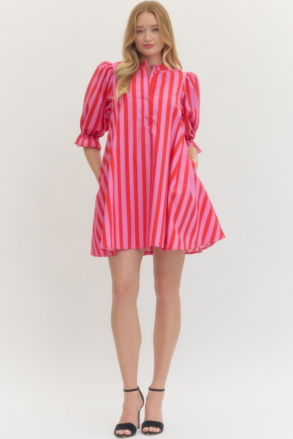 Woman wearing a red and white striped dress on a white background
