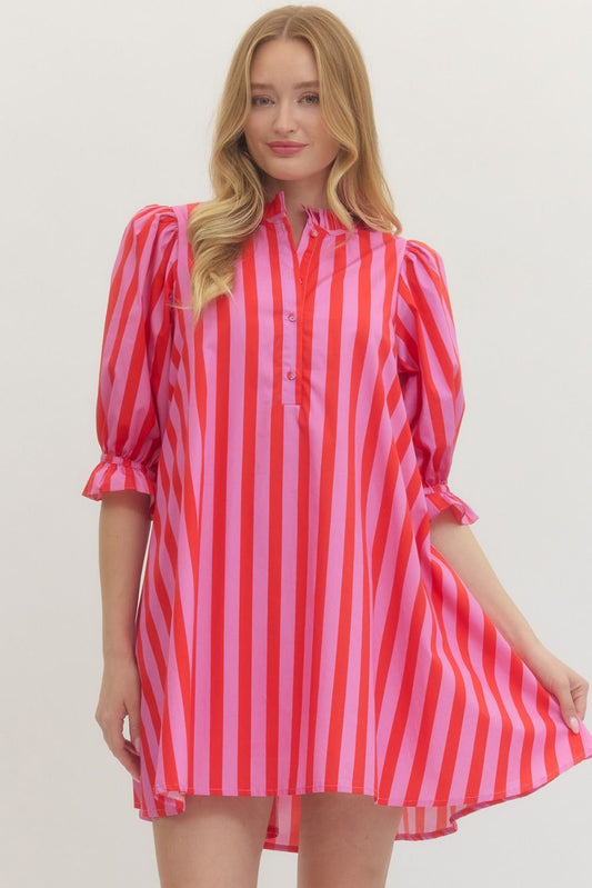 Woman wearing a red and pink striped dress on a white background