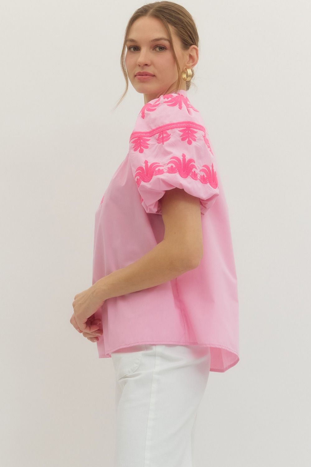 Pink embroidered blouse side profile showing puff sleeves