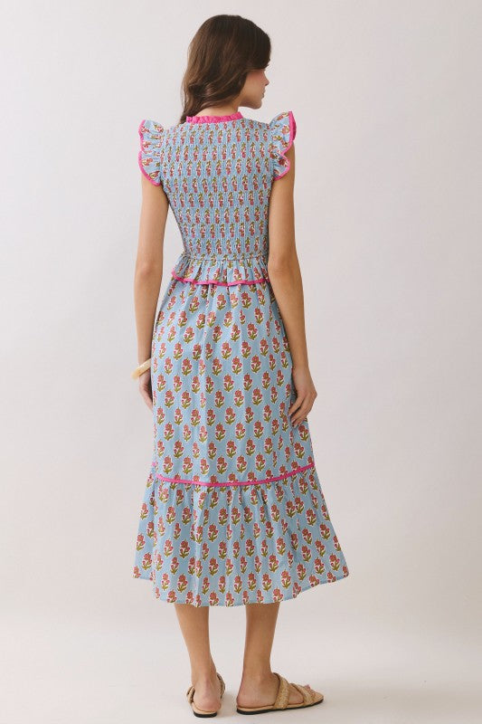 Pretty in Picnic Midi floral dress with blue background, pink trim, smocked bodice and ruffle sleeves