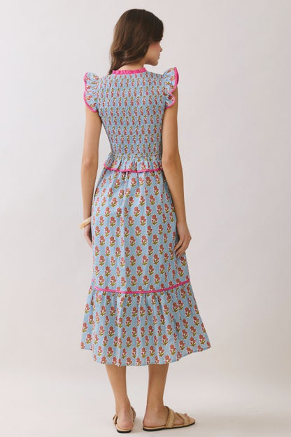 Pretty in Picnic Midi floral dress with blue background, pink trim, smocked bodice and ruffle sleeves