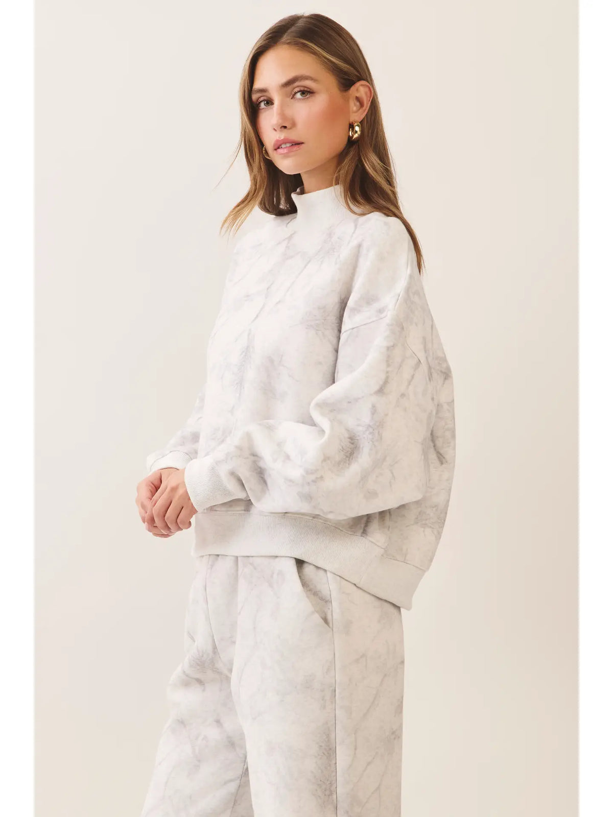 Marble print ivory and grey sweatshirt styled with matching pants side view