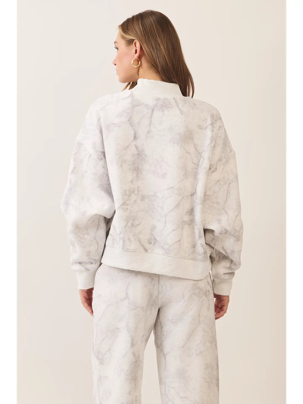 Back view ivory and light grey marble printed mock neck sweatshirt