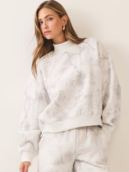 Close-up ivory and grey marble print sweatshirt with mock neck