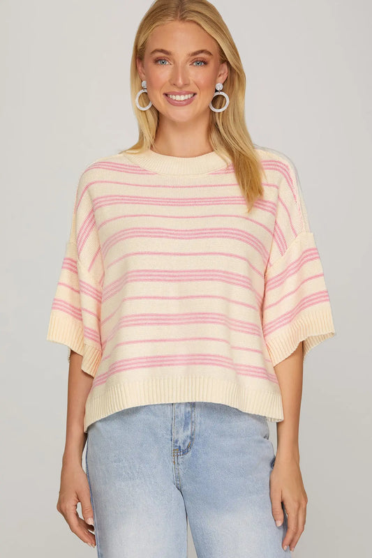 Model wearing cream and pink striped short sleeve knit sweater—front view.