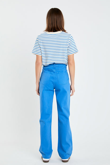 Person wearing a striped shirt and blue pants on a white background