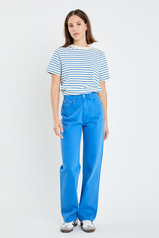 Woman wearing a striped shirt and blue pants on a white background