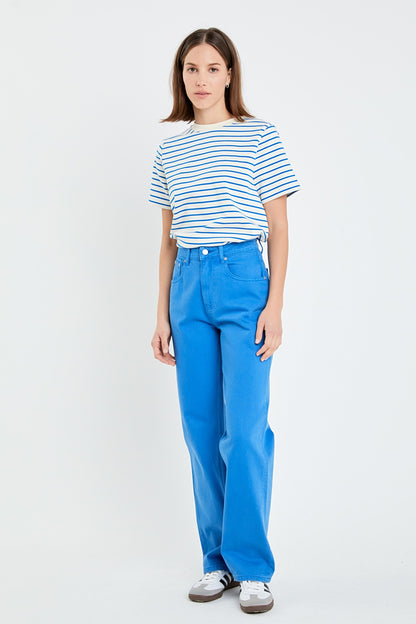 Person wearing a striped shirt and blue pants on a white background