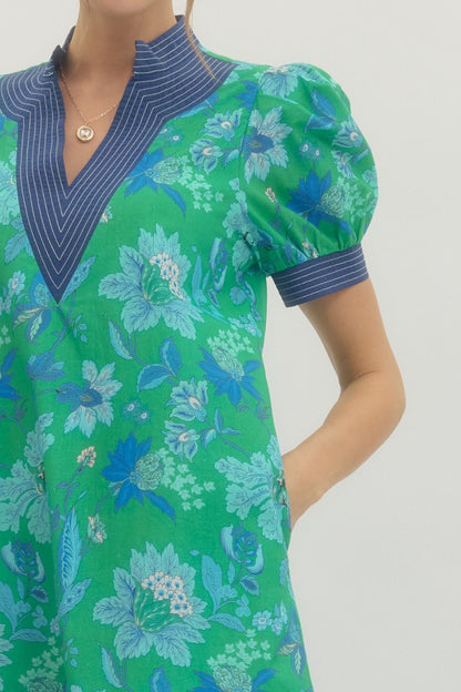 Green and blue floral dress with a plain background