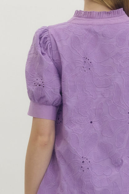 Purple floral dress with puff sleeves on a plain background