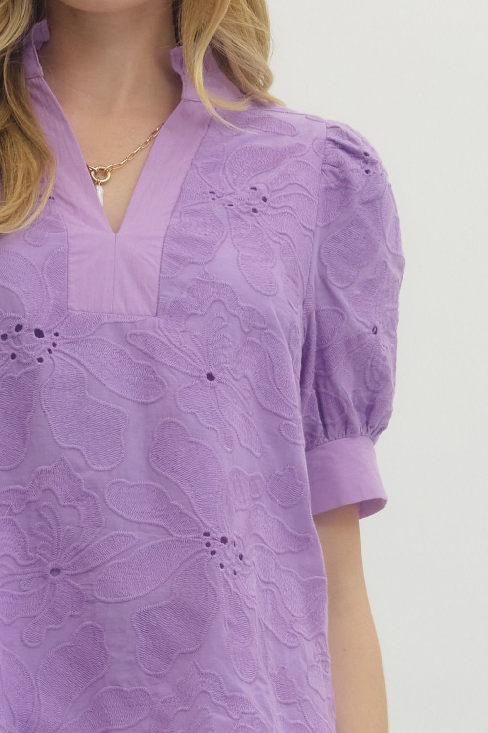 Purple floral dress with puff sleeves on a white background