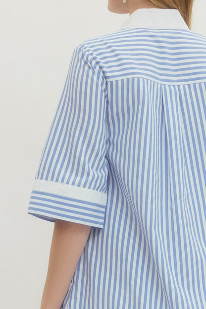 Blue and white striped shirt worn by a person on a plain background